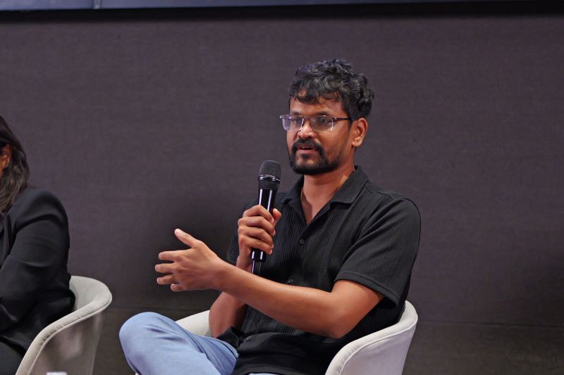 Pushpak Teja speaking into a microphone during a panel at Masters’ Union